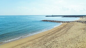 A beach with a rocky breakwater and calm waters. - Lorchidee Awajishima (Awaji)