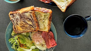 A meal with toast, eggs, ham, and salad on a plate, accompanied by a cup of coffee and a fork. - The 478 Pool & Spa Miyakojima Luxury Villa (Miyakojima)