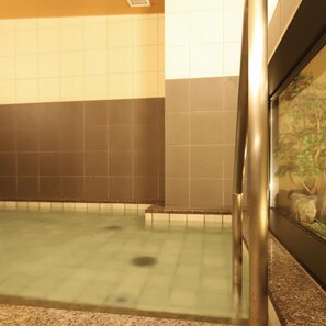 A bathroom with a tiled floor, a granite countertop, and a wall-mounted sink. - AB Hotel Konan (Konan)