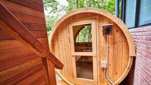 A wooden sauna with a glass door, a small window, and a hose attached to the side. - Hotel Anda-no-ouchi Izu Highland (Ito)