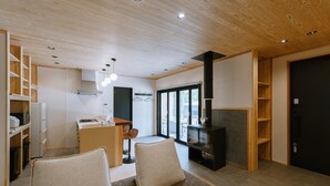 Ein modernes Wohnzimmer mit einer Couch, einem Kamin und einer Küchenzeile.