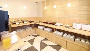 A modern kitchen area with a buffet setup, including various food items and storage containers. - AB Hotel Kani (Kani)