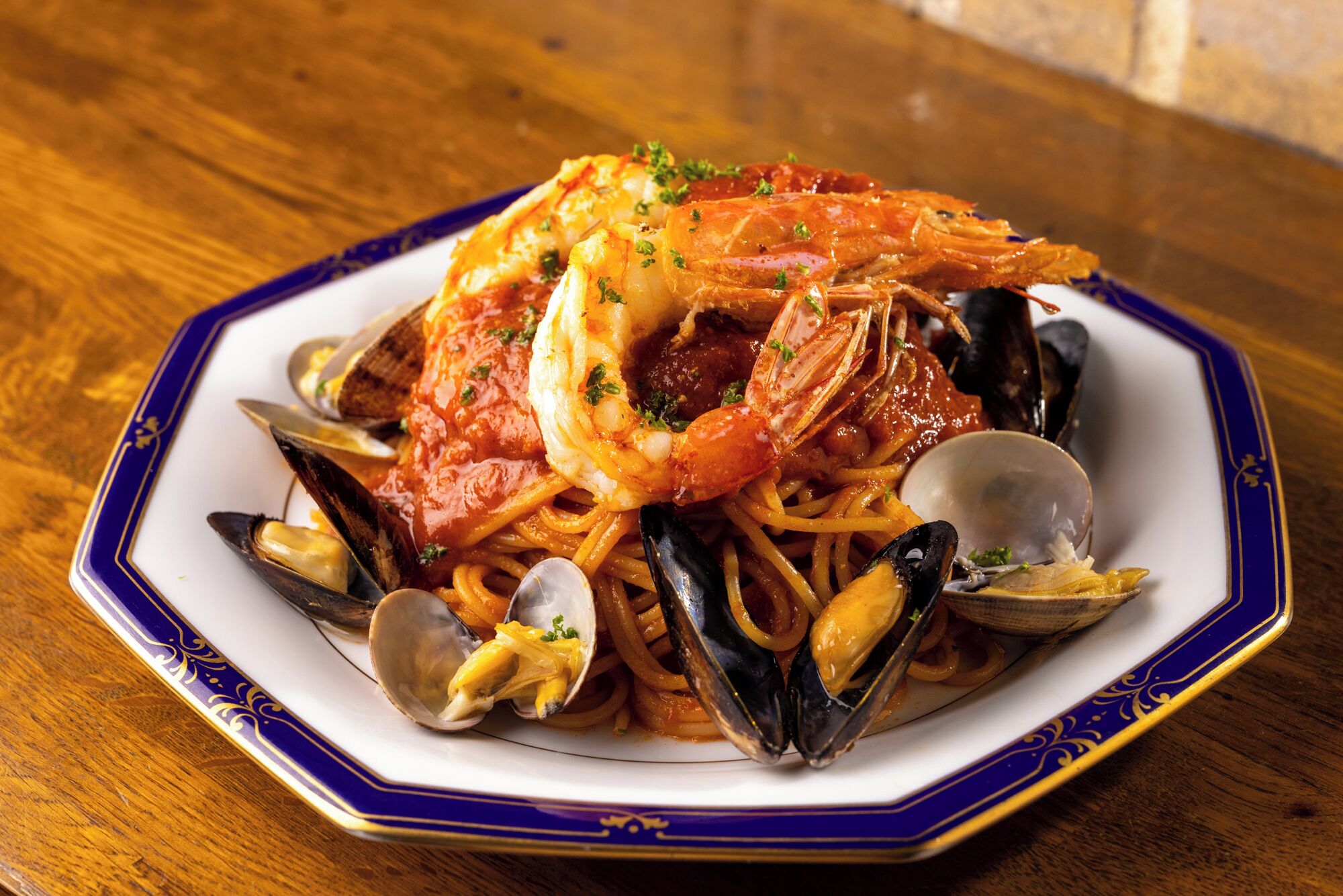 A seafood pasta dish on a decorative plate.