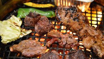 A grill with various meats and vegetables.
