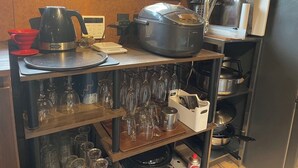 A kitchen with a coffee maker, a rice cooker, and various kitchen utensils. - Sato no Yado Rishi (Isumi)