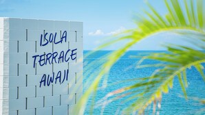 A sign reading "Isola Terrace Away!" with a view of the ocean and a palm tree in the foreground. - Isola Terrace Awaji (Awaji)