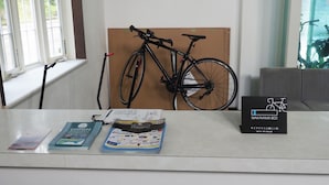 A reception desk with a bicycle, a sign for WAKAYAMA 800, and some brochures. - Youhuuminnsyuku Beisaidoinn Kushimotokan (Kushimoto)