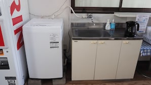 A compact kitchen with a refrigerator, a sink, and a coffee maker. - Youhuuminnsyuku Beisaidoinn Kushimotokan (Kushimoto)