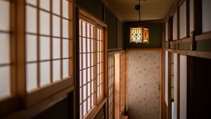 A traditional Japanese interior with sliding doors and a hanging lantern.