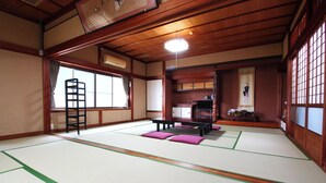 A traditional Japanese room with tatami flooring, a low table, a ladder, and sliding doors. - Katagiya (Kyotango)
