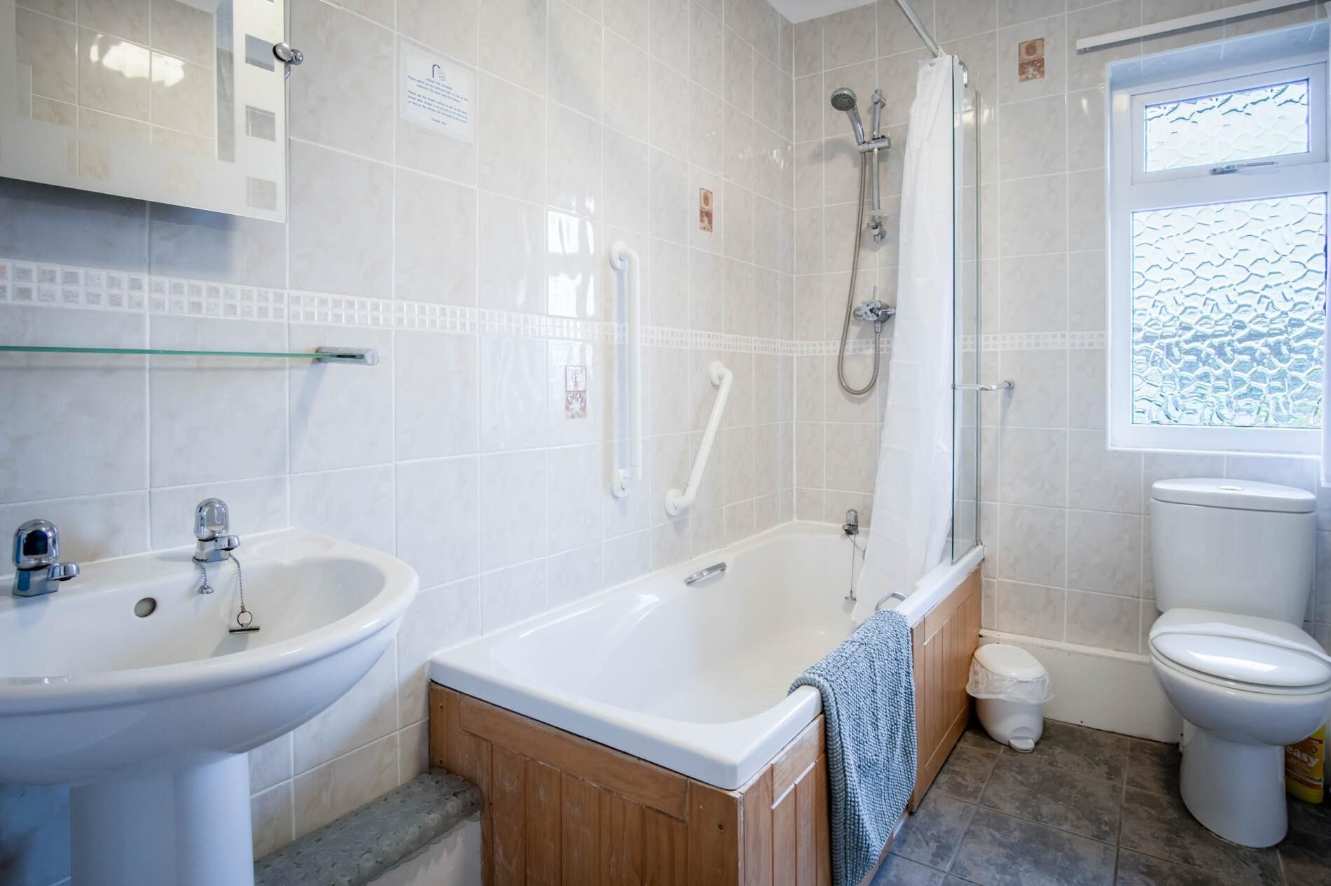 A bathroom with a bathtub, a sink, a toilet, and a shower.