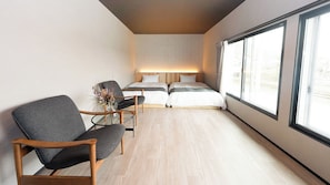 A modern hotel room with a large window, a bed with a headboard, a seating area with a chair and a table, and a vase with flowers. - Izumo Dogs (Izumo)