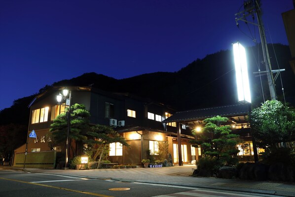 A two-story building with a sign indicating a public restroom. - Bandai Atami Onsen Yamashiroya (Koriyama)