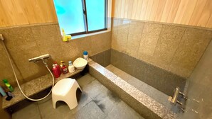 A bathroom with a bathtub, a toilet, and a window. - Myotoku-an (Kunisaki)