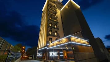 A multi-story hotel with a prominent marquee sign at the ground level.