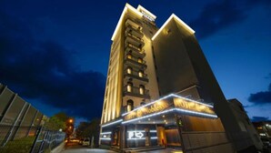 A tall hotel with a modern design, featuring multiple balconies and a prominent sign for the Hotel Noblesse. - Noblesse (Kobe)