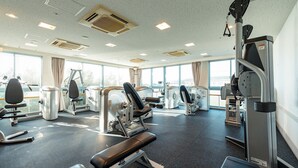 A gym with various exercise machines, large windows, and a ceiling with multiple light fixtures. - Lectore Hayama Shonan Kokusai Mura (Hayama)