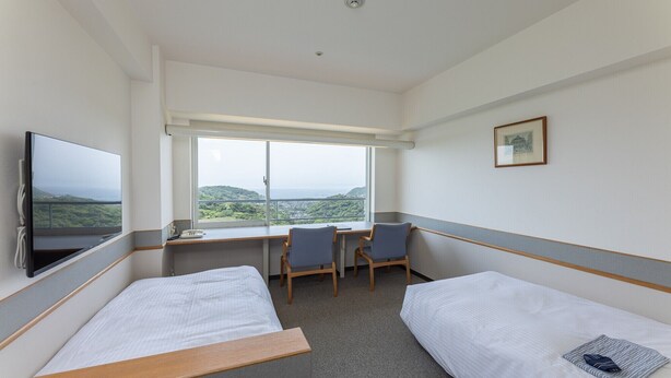 A hotel room with two single beds, a desk with a chair, a TV, and a large window offering a view of the landscape. - Lectore Hayama Shonan Kokusai Mura (Hayama)