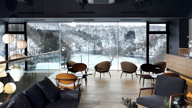 A modern interior with large windows offering a snowy landscape view. - Etchu Goi Hanao Onsen Yamaboushi (Takaoka)