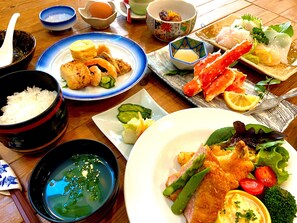 A variety of dishes including sushi, sashimi, and a salad with vegetables. - Tomonoyu Ryokan (Iwaki)