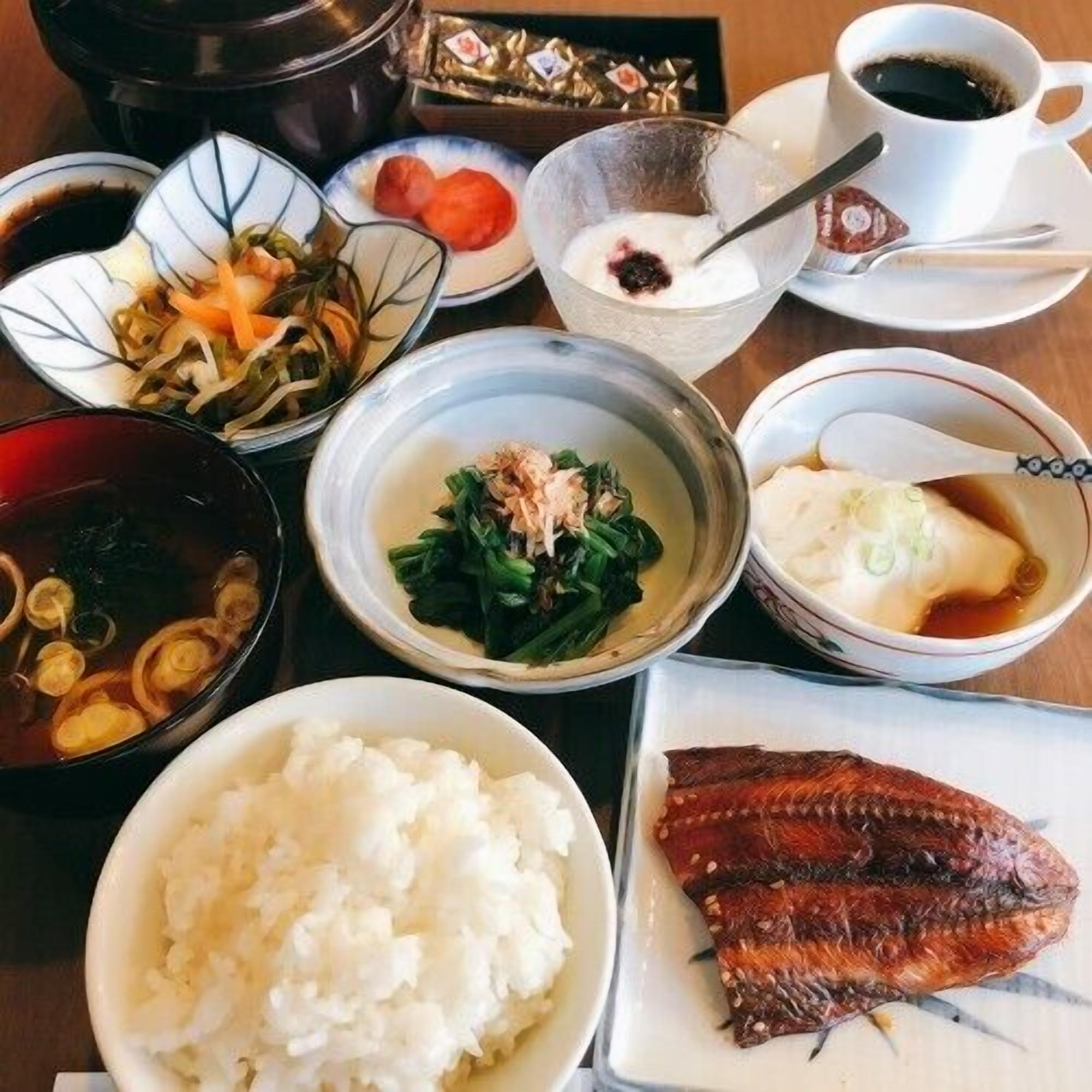 A variety of dishes including fish, rice, and vegetables, suggesting a meal setting.