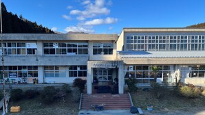 A multi-story building with a central entrance, large windows, and a flat roof. - Sanriku Active (Ofunato)