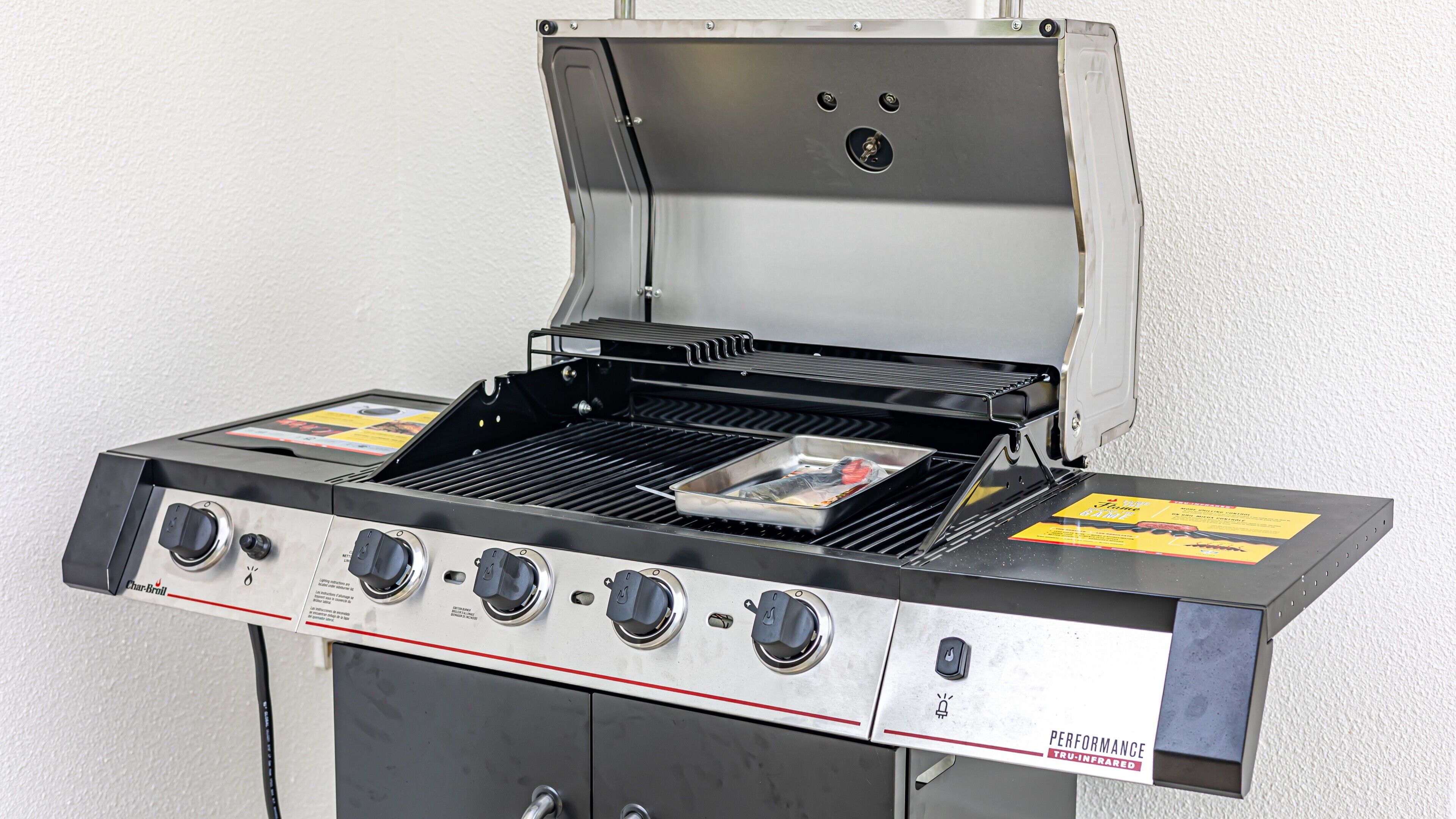 A Char-Broil gas grill with four burners, a side burner, and a griddle.