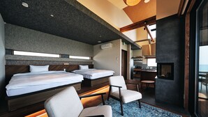 A modern hotel room with two beds, a seating area, and a view of the sea. - Private Villa Yuhimi ~sunset Hill~ (Aki)