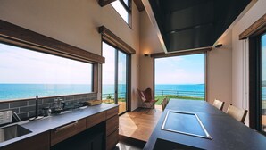 A modern kitchen with large windows overlooking the sea. - Private Villa Yuhimi ~sunset Hill~ (Aki)
