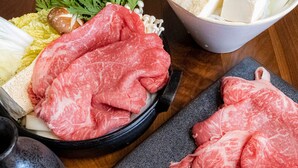 A variety of raw meats, vegetables, and tofu on a wooden table. - Coral Resort Villa Atsuhama (Sumoto)