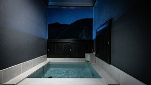 A modern indoor pool with a night sky mural on the ceiling, surrounded by dark walls and a tiled floor. - Awa Nishi-izu (Numazu)