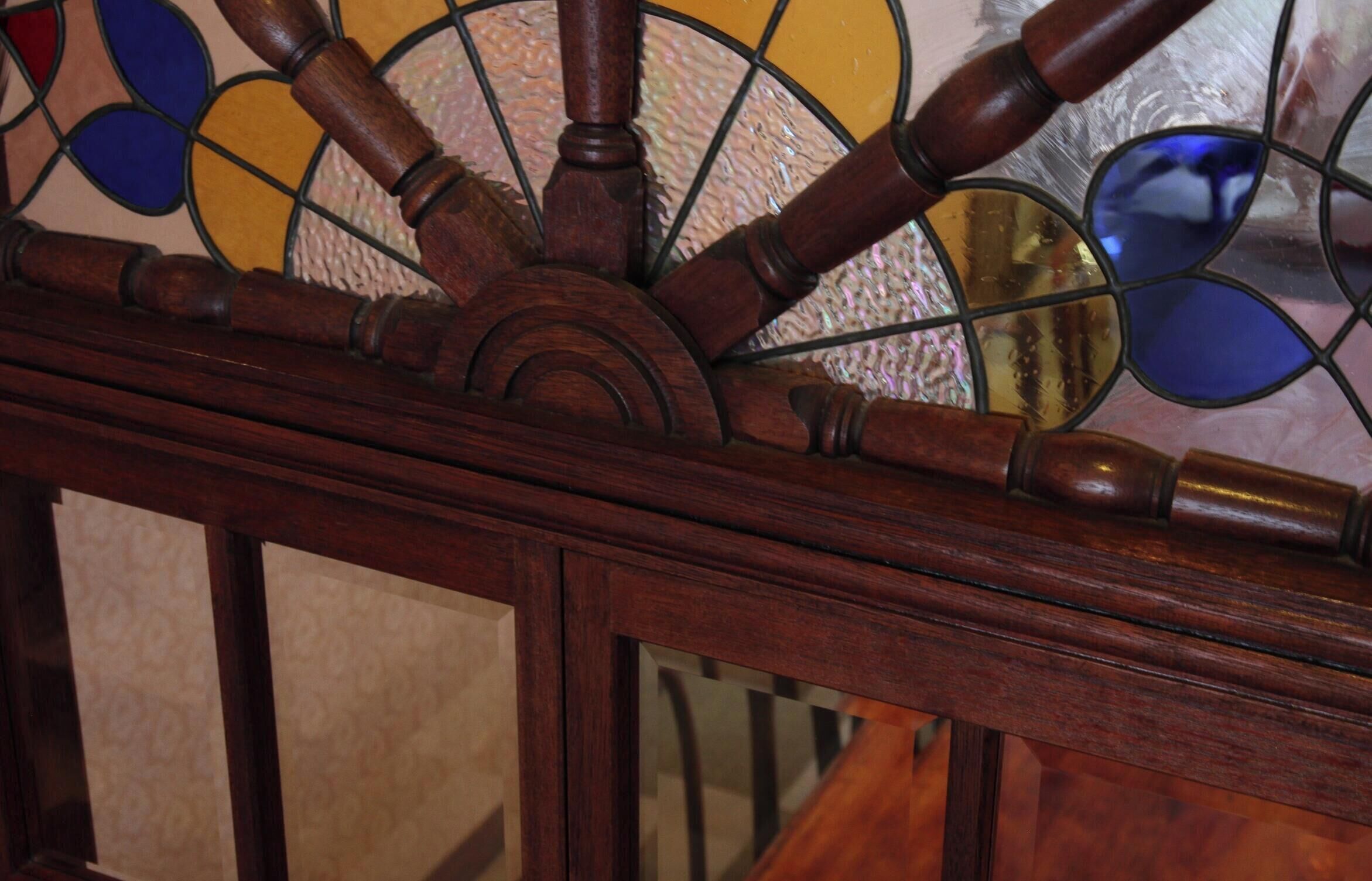 A stained glass window with a wooden frame.