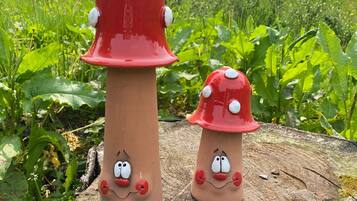 Two mushroom-shaped sculptures with faces on a tree stump.