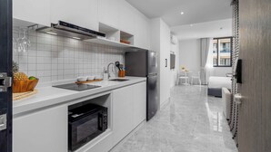 A modern kitchen with white cabinetry, a built-in oven, and a stainless steel refrigerator. - 1BR w Pool Gym near Nai Harn C266 (Rawai)