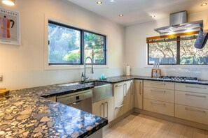 Microwave, stovetop, dishwasher - Villa De La Isla - Onetangi - Villa de la Isla is a stylish Waiheke retreat near Onetangi Beach and shops. Featuring 3 queen bedrooms, 2 bathrooms, games room, private Buddha Bar, hot tub with ocean views, and fun gardens, its perfect for relaxing or (Waiheke Island)