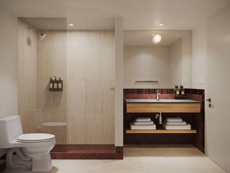 A modern bathroom with a shower, toilet, vanity with a sink, and a towel rack.