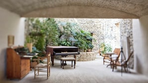 Un modelo a escala de una habitación acogedora con un piano, sillas y plantas en macetas.