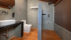 A modern bathroom with a large sink, toilet, and shower area. - Sherbaug Nature Park & Resort (Panchgani)