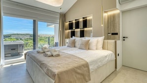 A modern bedroom with a large bed, a ceiling light, a view of the outdoors, and a built-in TV.