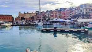 A marina with boats docked, surrounded by colorful buildings and a clear sky. - Beautiful apartment for 4 guests with A/C, WIFI, TV and terrace (Santa Margherita Ligure)