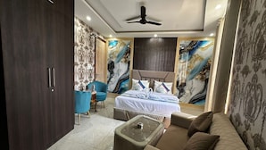 A modern bedroom with a bed, a sofa, a coffee table, and a wardrobe.