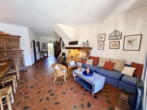 A spacious living area with a sofa, chairs, a coffee table, and a fireplace. - Large fisherman's house near beach - 4 terraces, WiFi, parking (Port Grimaud)