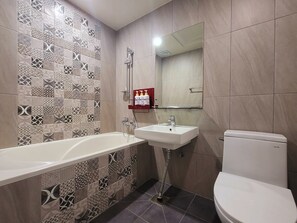 A bathroom with a bathtub, sink, and toilet. - ORAGO stay hotel (Suwon)