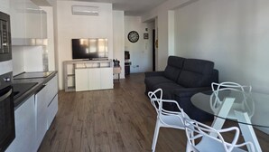 A modern living space with a kitchen, dining area, and seating. - Imperatore suites (Rome)