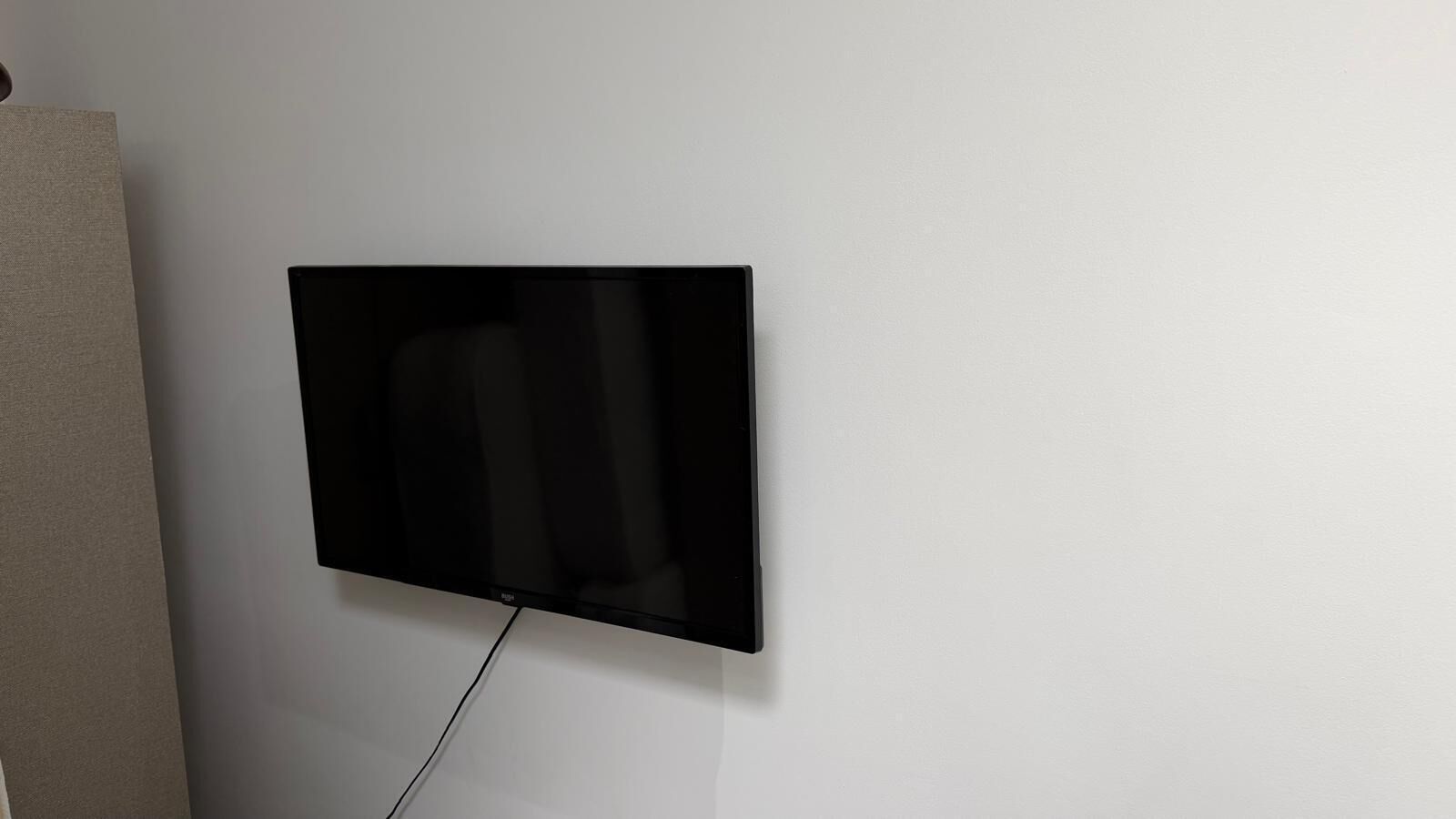 A flat-screen TV mounted on a plain wall.