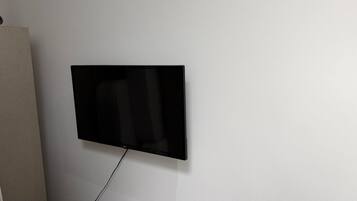 A flat-screen TV mounted on a plain wall.