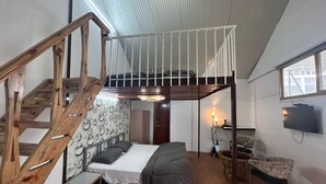 A compact room with a bunk bed, a wooden staircase, a small table, and a chair. - The Chail Heights Hotel & Resort (Shimla)