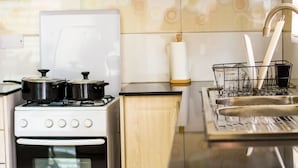 A kitchen with a stove, oven, and sink.