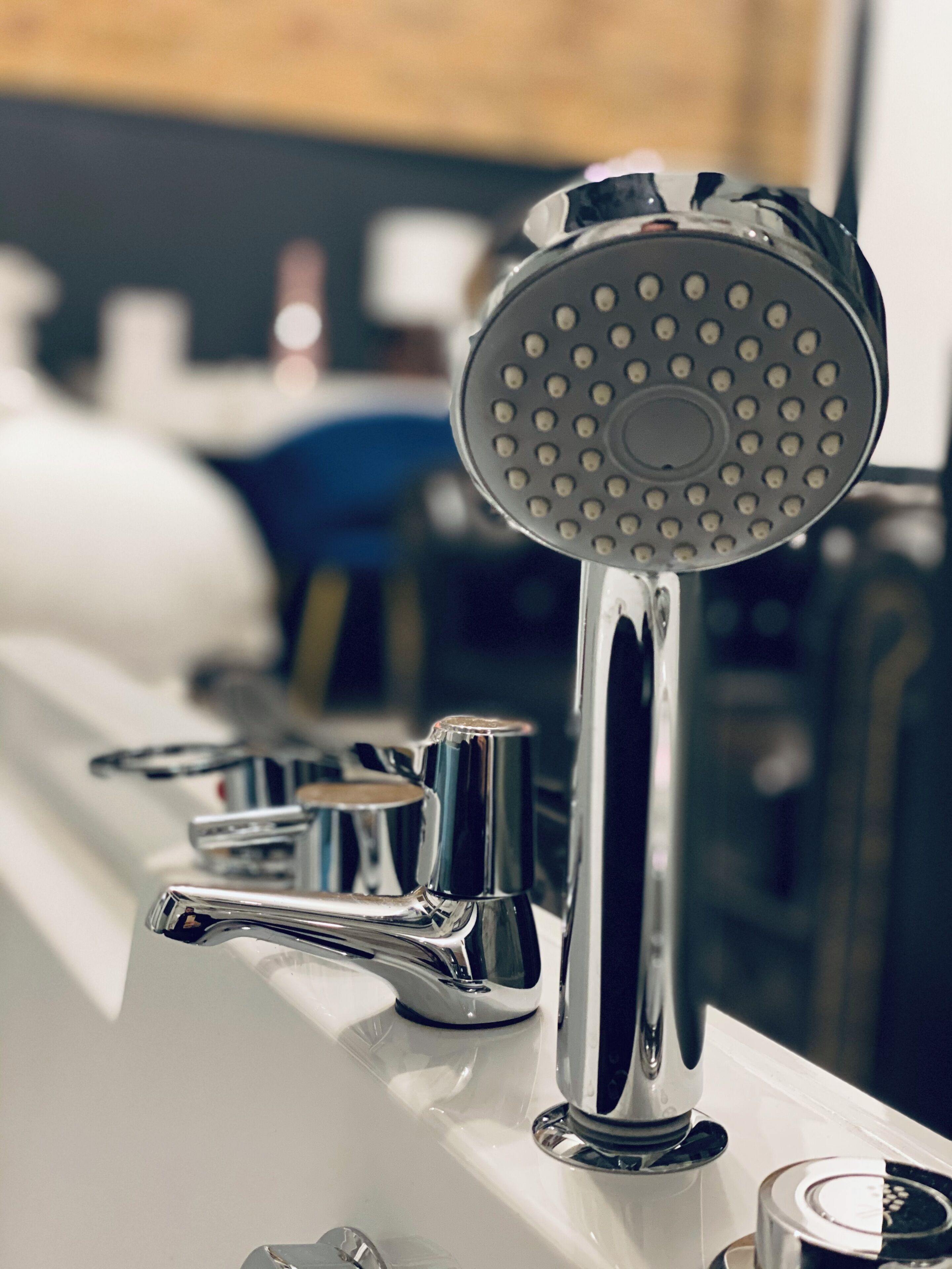 A bathroom with a modern shower head and chrome fixtures.