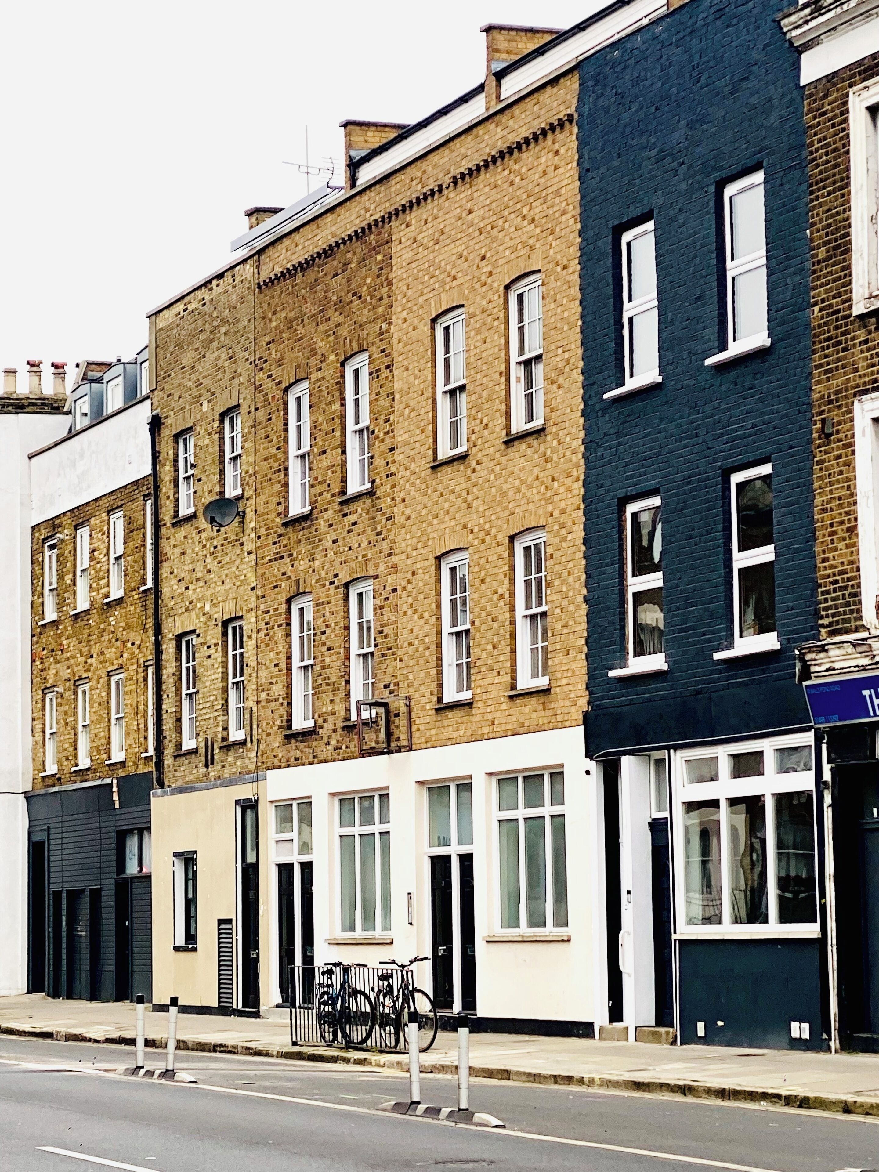 A row of multi-story buildings with uniform window patterns and a flat facade.